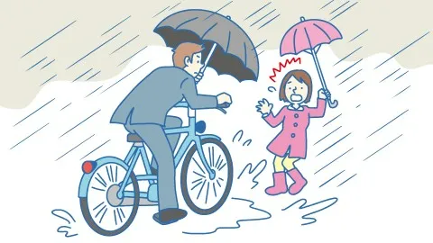 男性が傘を差して前が見えない状態で自転車を運転し、前方にいる歩行者にぶつかりそうになっているイメージ図。