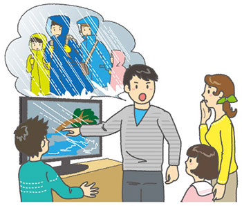 テレビの気象情報を見て、家族に向かって避難について話している男性
